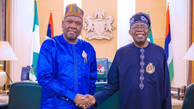 Picture of Former spokesman of the defunct Atiku-Okowa Presidential Campaign Council, Daniel Bwala and President Bola Tinubu Check hand